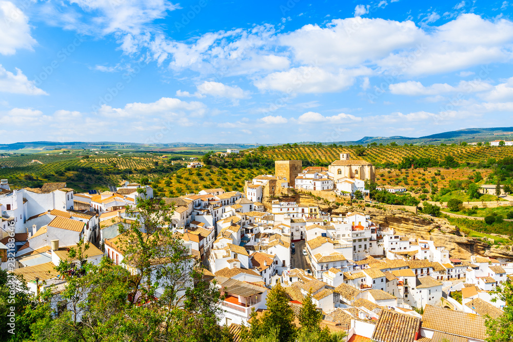 White houses and church on hilltop in beautiful mountain village Setenil de las Bodegas, Andalusia, Spain