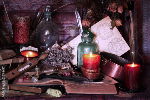 Antique Magic Book. Witchcraft Peacock feathers and candle background. Black candle Magic Ritual.