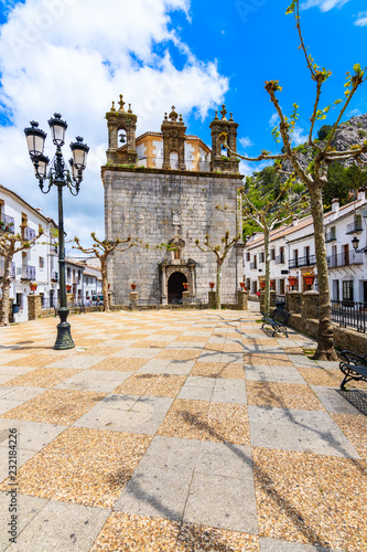 Church facade and white houses in Grazalema mountain village, Andalusia, Spain