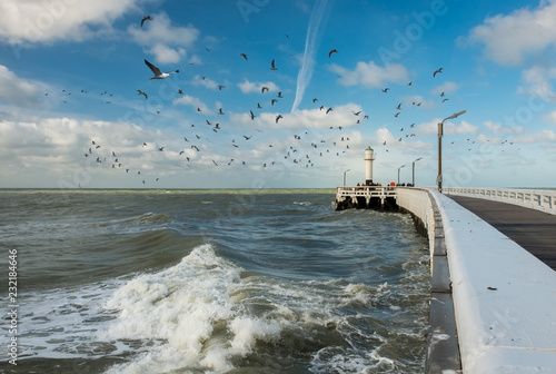 View on waves and old wooden pier of Nieuwpoort