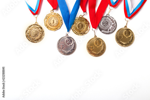 Gold and silver medals with ribbon on white background. Isolated. Copy space