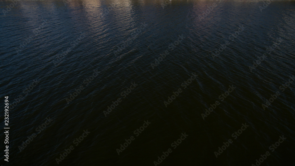 Top view of the black water of the lake at night. Mystical lake Top view of the black water of the lake at night. Mystical lake