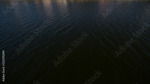 Top view of the black water of the lake at night. Mystical lake