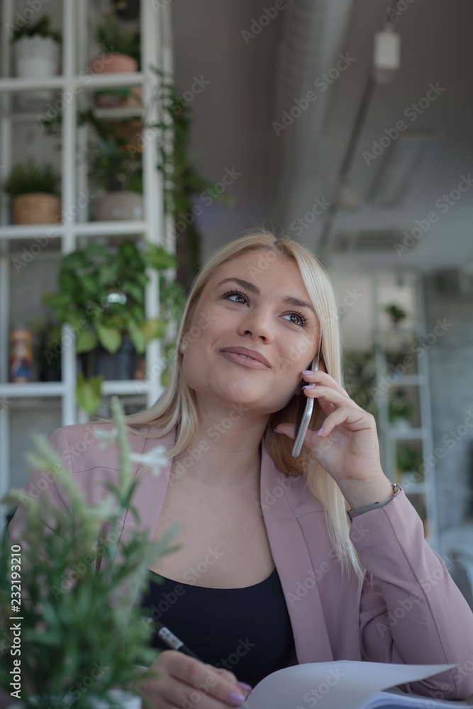 Businesswoman using phone.