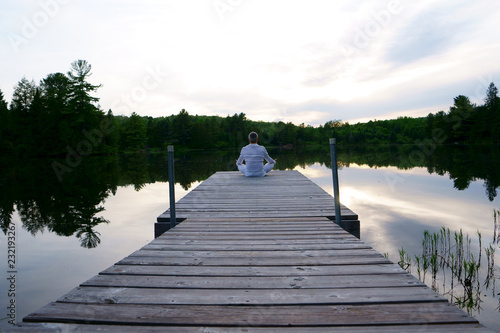 Portrait of a proud healthy caucasian man, 50, wearing a white suit, after a meditation session by the river at the sunset. © Studio Specialty