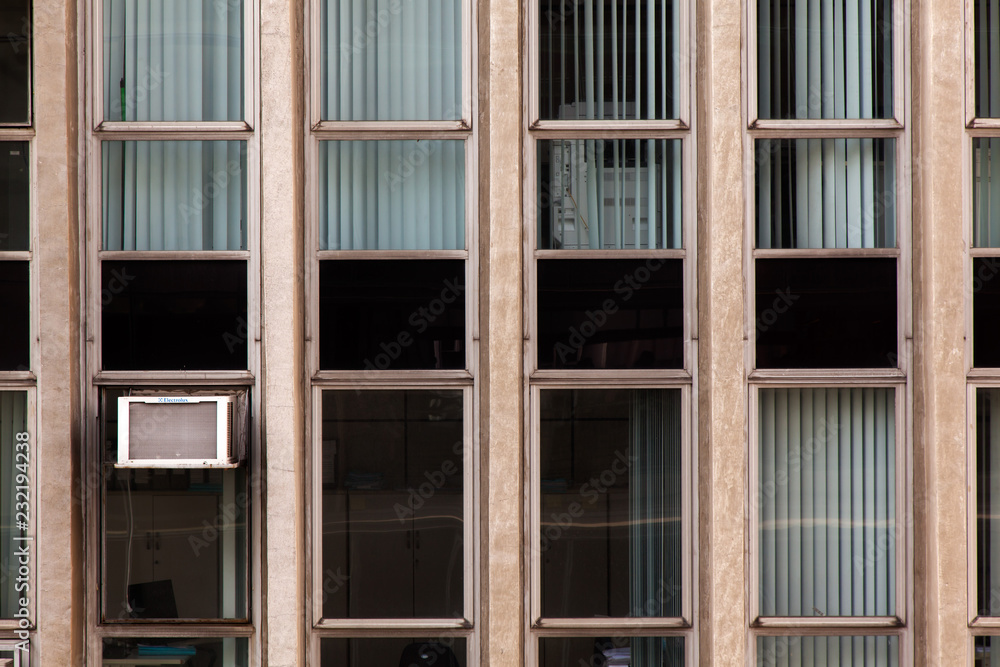 Modern glass windows in concrete building facade - urban modern architecture Modern glass windows in concrete building facade - urban modern architecture
