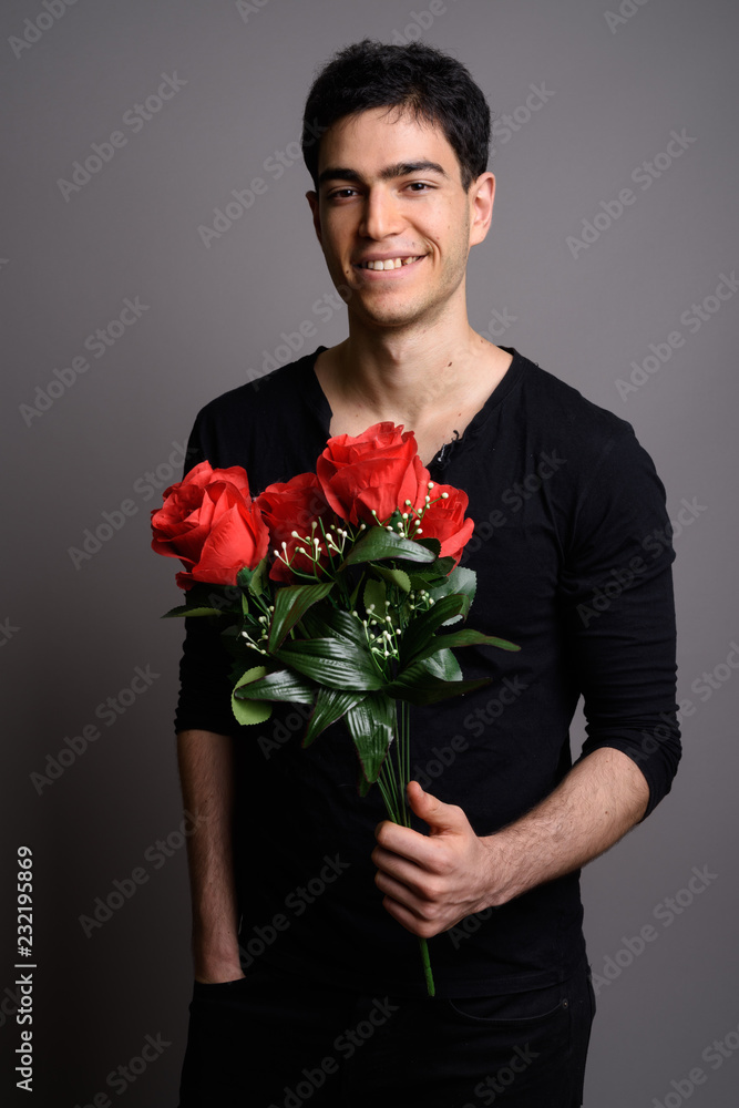 Portrait of young handsome man against gray background Portrait of young handsome man against gray background