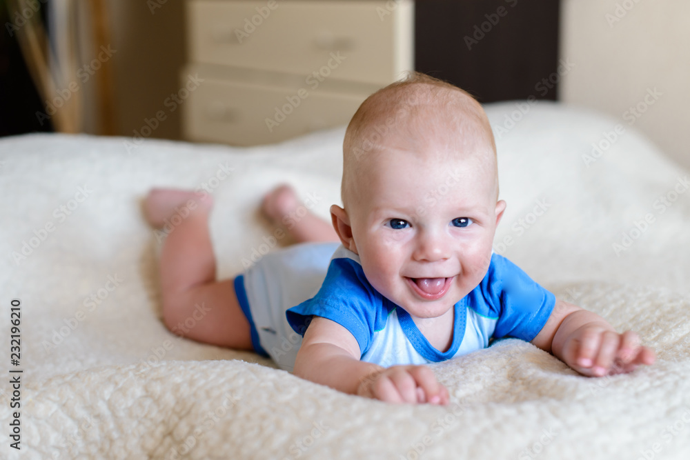 Happy Adorable baby boy learning to crawl