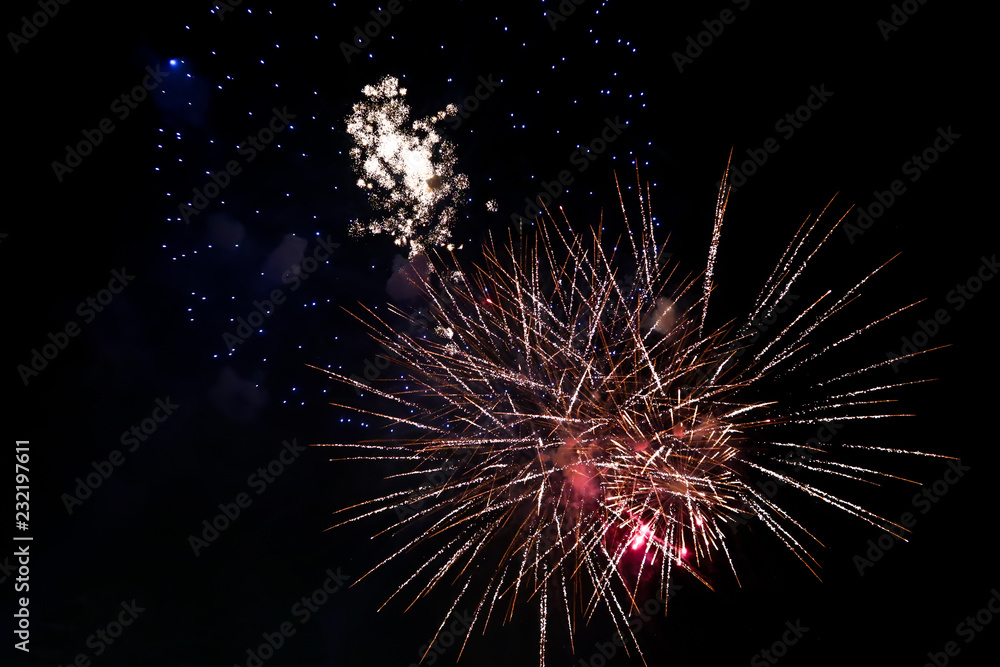 Abstract colored firework  on the night sky with smoke New Year celebration, amazing fireworks isolated in dark background close up