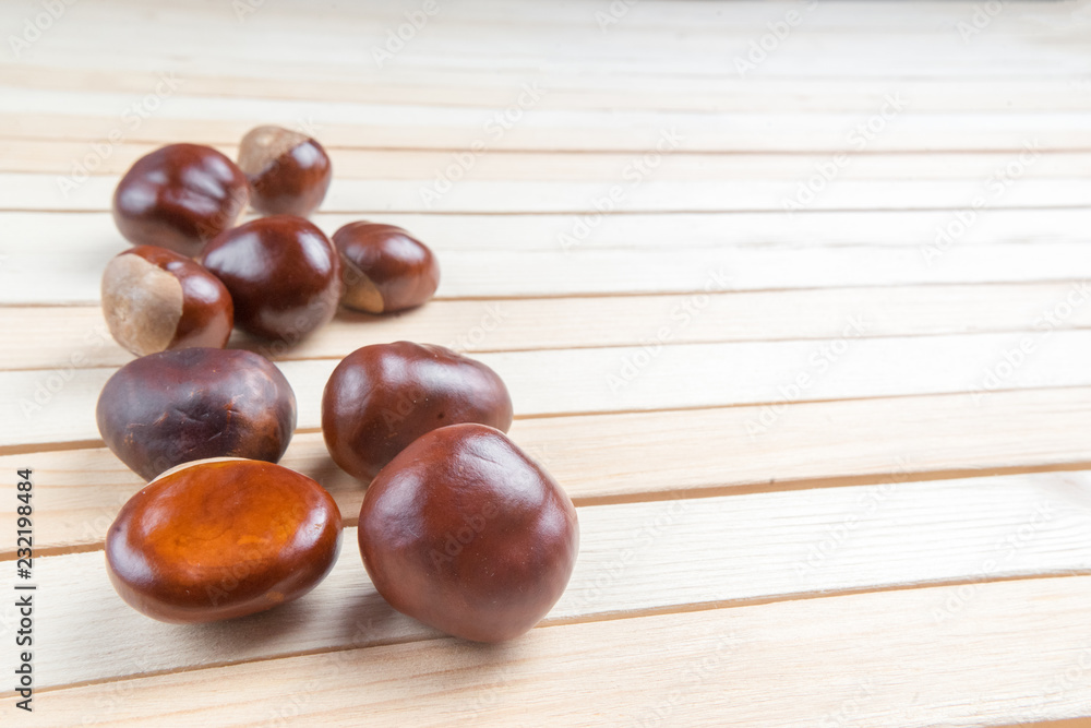 Horse Chestnut for Christmas on wooden background, selective focus. With your place for the text Horse Chestnut for Christmas on wooden background, selective focus. With your place for the text
