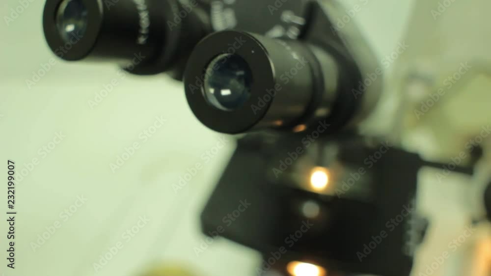 Close up of examining of test sample under the microscope in laboratory. Close up of examining of test sample under the microscope in laboratory.