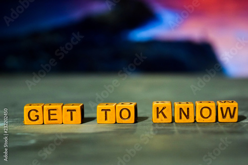 Get to know on wooden blocks. Cross processed image with bokeh background