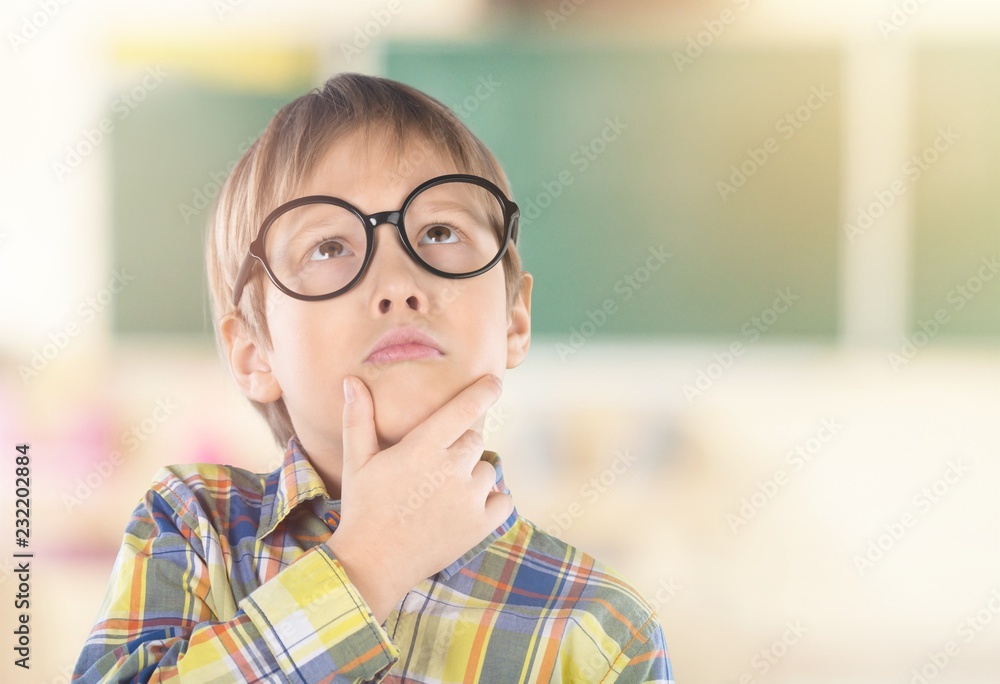 Portrait of a cute young boy with glasses isolated on Portrait of a cute young boy with glasses isolated on