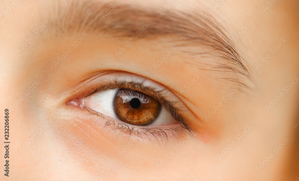 Obraz premium Close-up shot of beautiful brown eye of little girl with reflection. No make up. Naturality concept