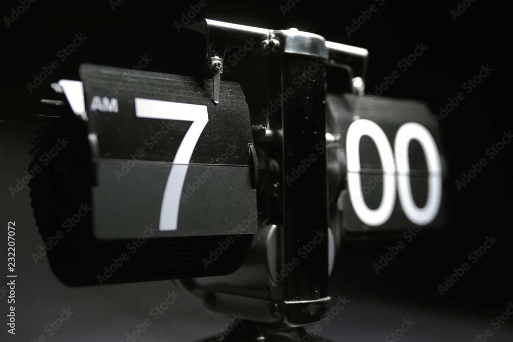 Classic flip clock watch face showing hour and minutes set to 700 AM