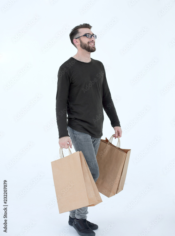 Portrait of a man with a full paper bag on a gray Portrait of a man with a full paper bag on a gray