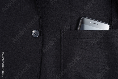 Black phone with camera in the pocket of blue jacket. Good present.