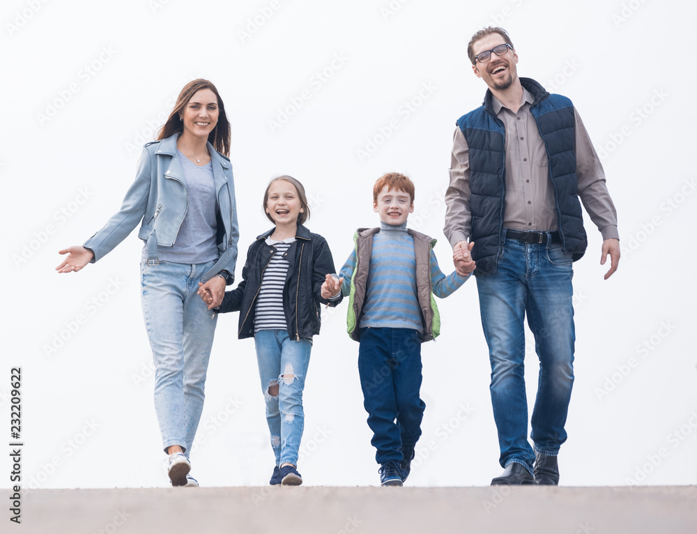Obraz premium Happy family holding hands and walking