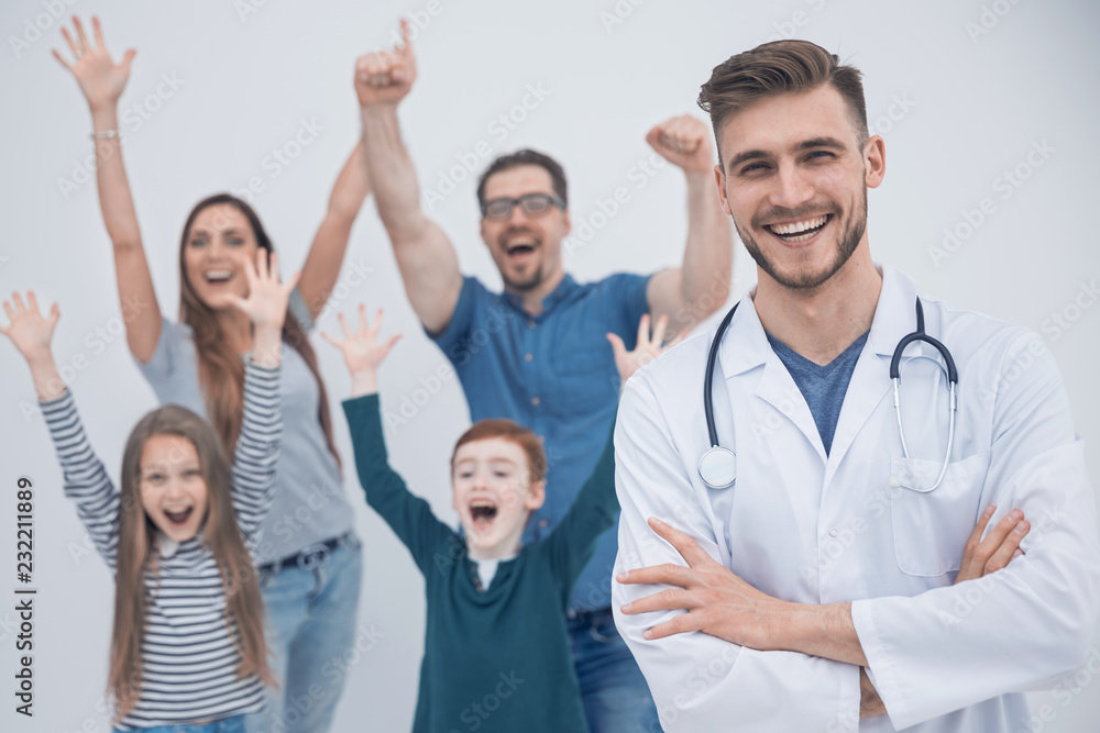 smiling doctor on the background of a happy family smiling doctor on the background of a happy family