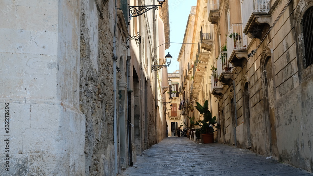 Ortigia Island, Sicily. Early in the morning, the narrow streets are still calm. Ortigia Island, Sicily. Early in the morning, the narrow streets are still calm.