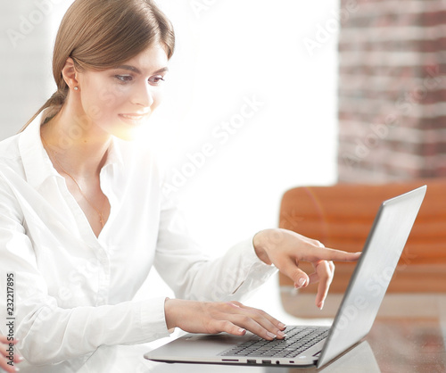woman Manager shows the client information on the laptop. © ASDF