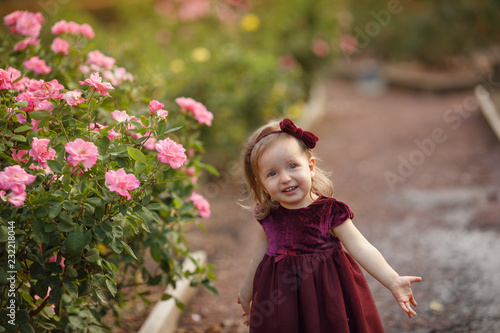 happy little girl in a flower garden