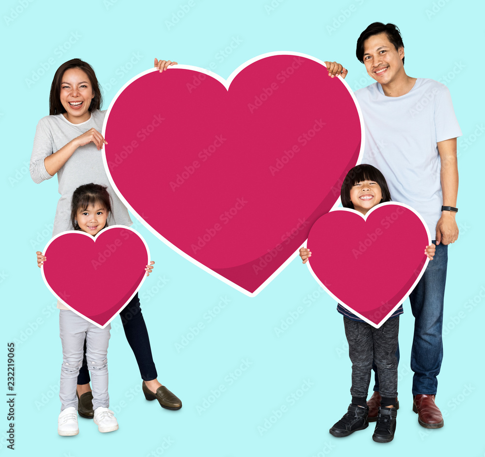 Happy family holding heart icons