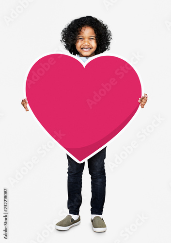 Foto Happy kid holding a heart icon