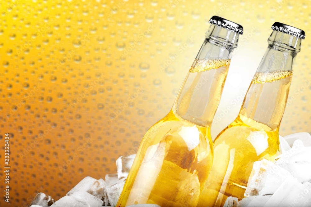 Bottles of cold and fresh beer with ice isolated on white Bottles of cold and fresh beer with ice isolated on white