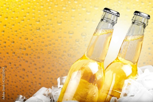 Bottles of cold and fresh beer with ice isolated on white