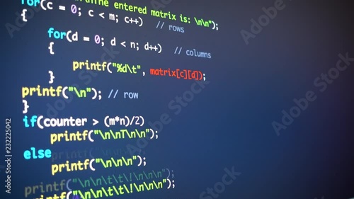 Scrolling down the programming code on computer monitor