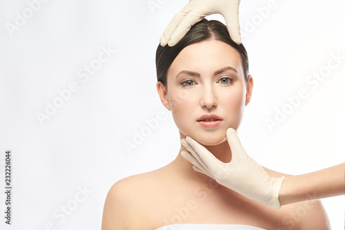 Plastic medical consultation. Doctor hands. Woman face photo