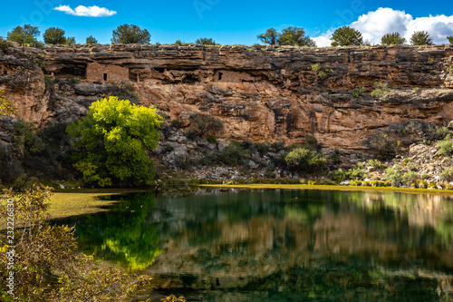 Ancient ruins and surroundings reflect on the quiet water of Montezuma Well. Part of Montezuma Castle National Monument. photo