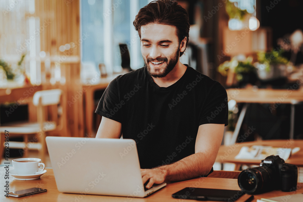 Fototapeta premium Portrait of Smiling Freelancer Working on Laptop