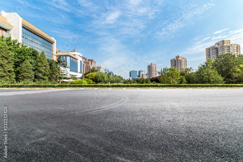 Panoramic skyline and modern business office buildings with empty road,empty concrete square floor photo