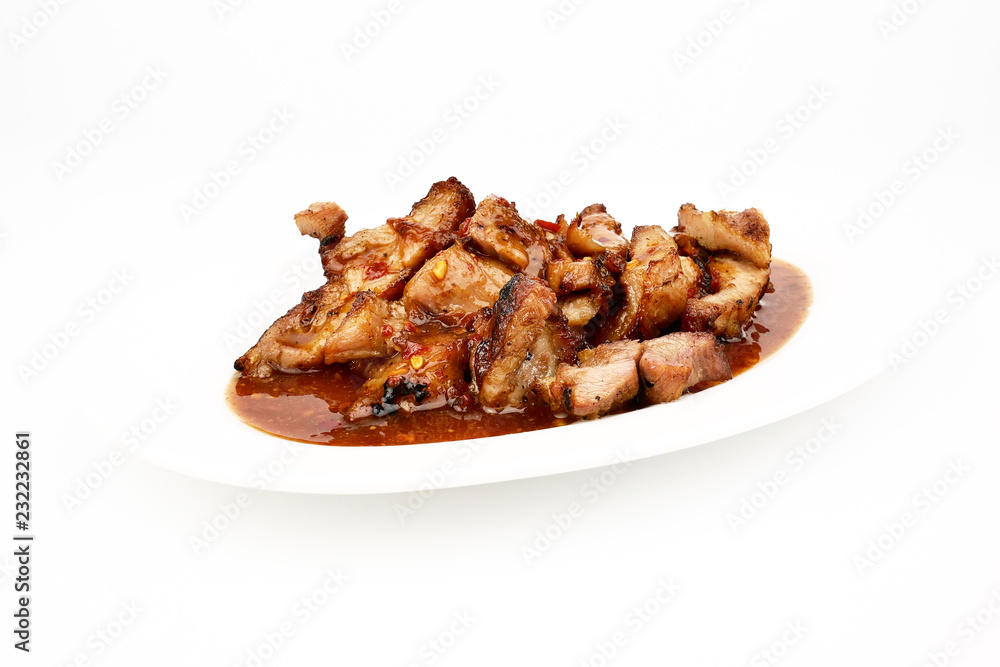 Assorted delicious Grilled pork and spicy sauce on a white plate isolated on white background Assorted delicious Grilled pork and spicy sauce on a white plate isolated on white background