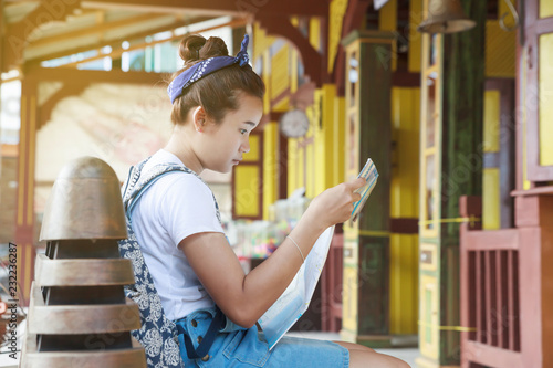 Woman traveler reading the map at train station. 