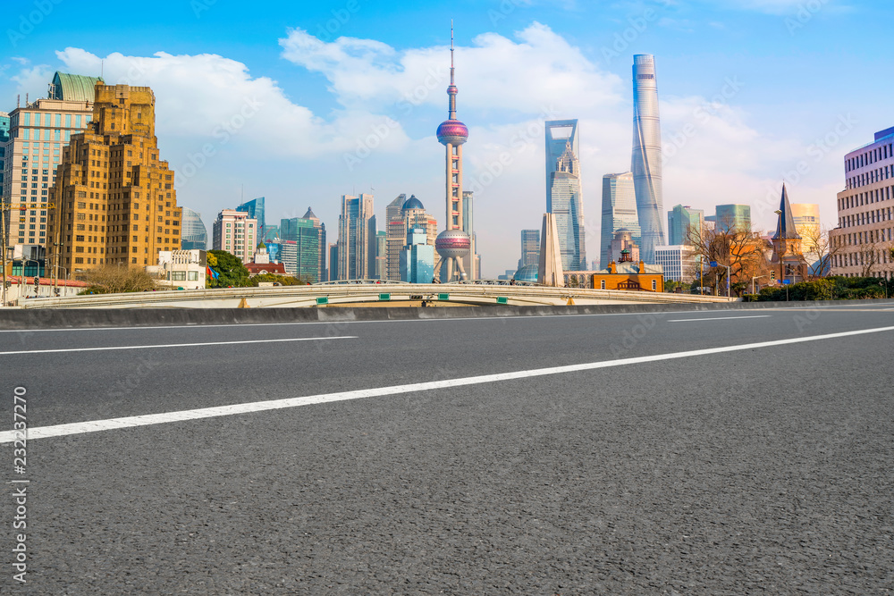 Empty asphalt road along modern commercial buildings in China's cities