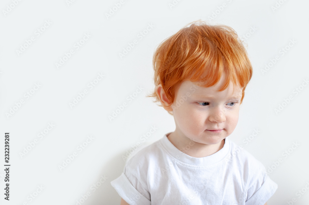 Pensive redhead boy on a white background Pensive redhead boy on a white background