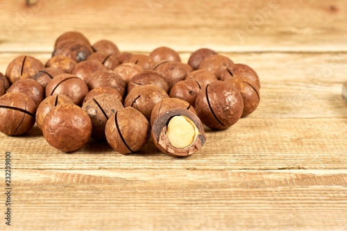 Macadamia nuts on wooden table with copyspace, close-up