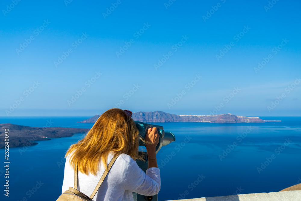 Luxury travel vacation woman looking at view on Santorini island Luxury travel vacation woman looking at view on Santorini island