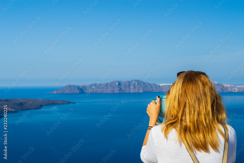 Luxury travel vacation woman looking at view on Santorini island Luxury travel vacation woman looking at view on Santorini island