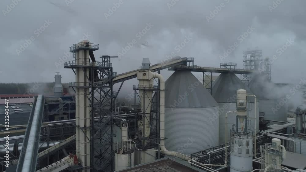 Woodworking factory aerial view of pipes and tanks, industrial landscape. Woodworking factory aerial view of pipes and tanks, industrial landscape.