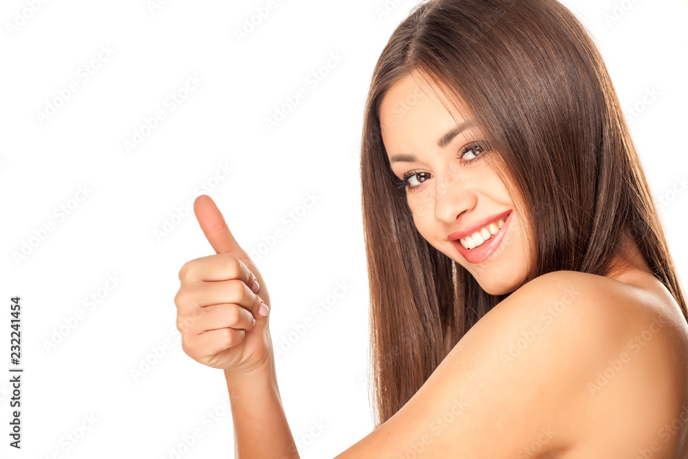 Portrait of young beautiful woman with makeup on white background and showing thumbs up Portrait of young beautiful woman with makeup on white background and showing thumbs up