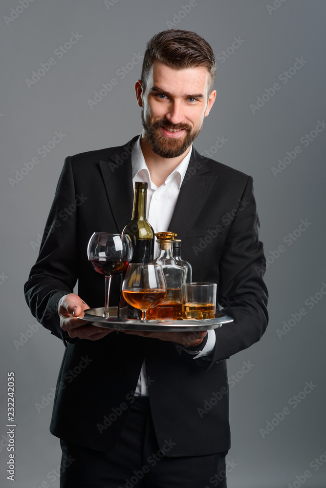 Sommelier carrying tray with beverages Sommelier carrying tray with beverages