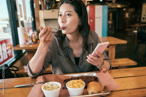 young lady eating meal with fork.