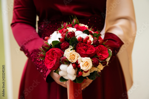 Wedding bouquet of flowers in the hands of the bride