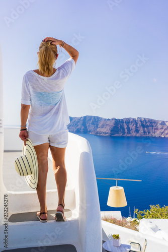 Photography Luxury travel vacation woman looking at view on Santorini island