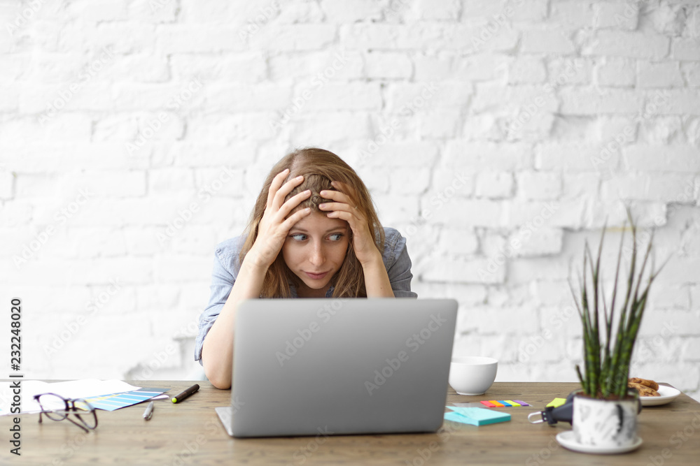 © Anatoliy Karlyuk - Frustrated young woman looking at laptop with stressed facial expression, keeping hands on head, troubled with shocking news. Unexpected computer crash, shocking news, fatal error, data loss © Anatoliy Karlyuk - Frustrated young woman looking at laptop with stressed facial expression, keeping hands on head, troubled with shocking news. Unexpected computer crash, shocking news, fatal error, data loss