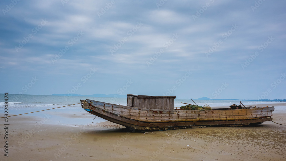 Old fishing boat on the sea shore. Mong Kai, Vietnam